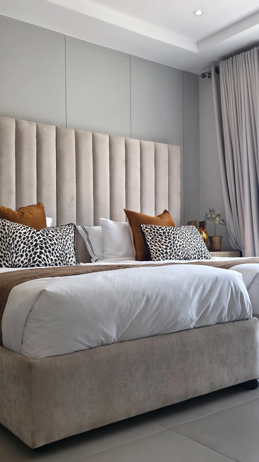 Esfog Lodge, Kadoma: bedroom with neutral upholstery, a tall headboard and daylight