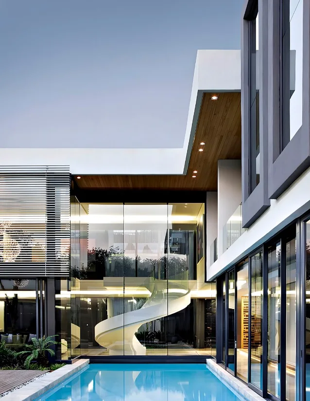 Modern home design with a sculptural staircase, floor-to-ceiling glazing and a swimming pool