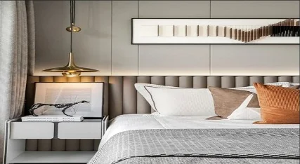 Bedroom design with layered bedding and a warm bedside light