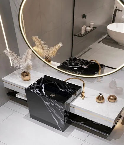 Bathroom vanity design with a circular mirror and dark stone basin